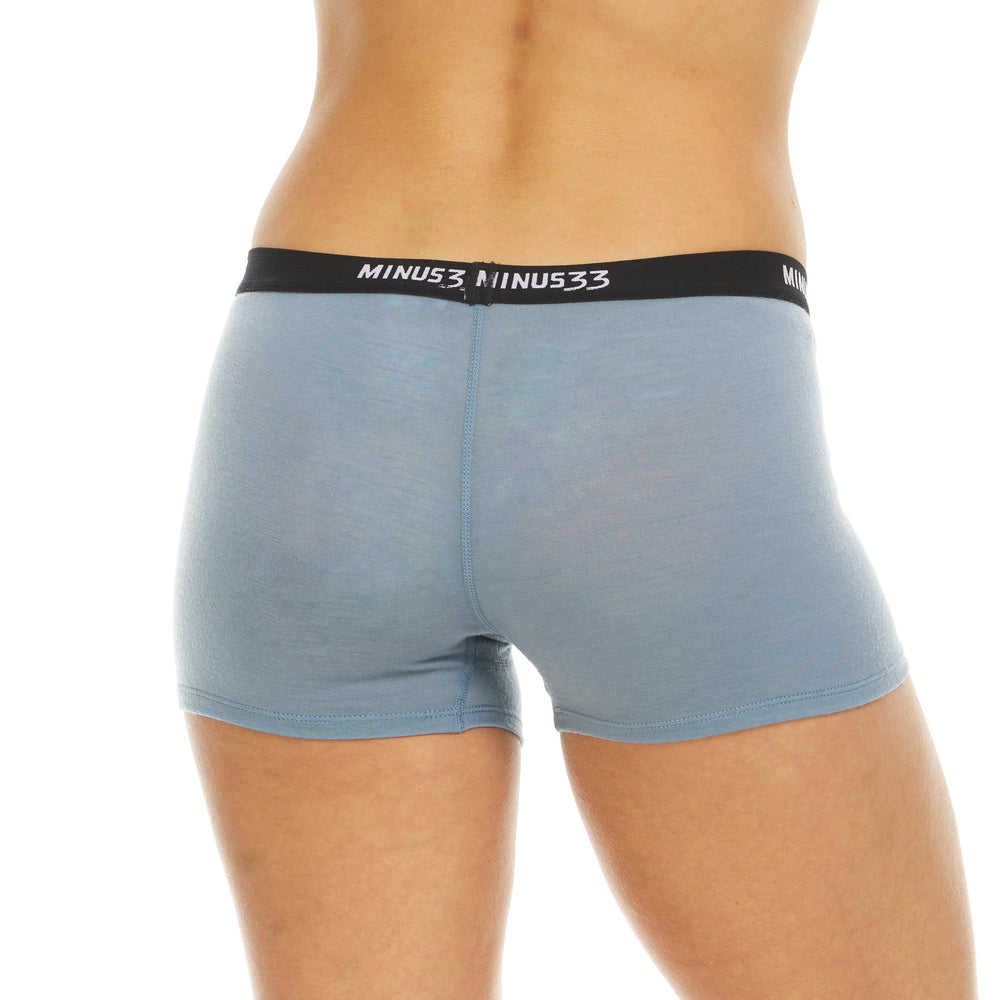 A woman models the microweight merino wool boyshorts. The boyshorts have a one inch inseam and a one inch woven sport elastic waistband #color_slate-blue