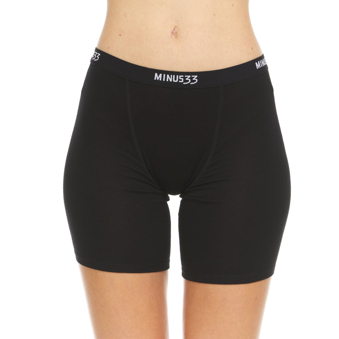 A woman models the microweight merino wool women's boxer briefs. The boxer briefs have a five inch inseam and a one inch woven sport elastic waistband #color_black