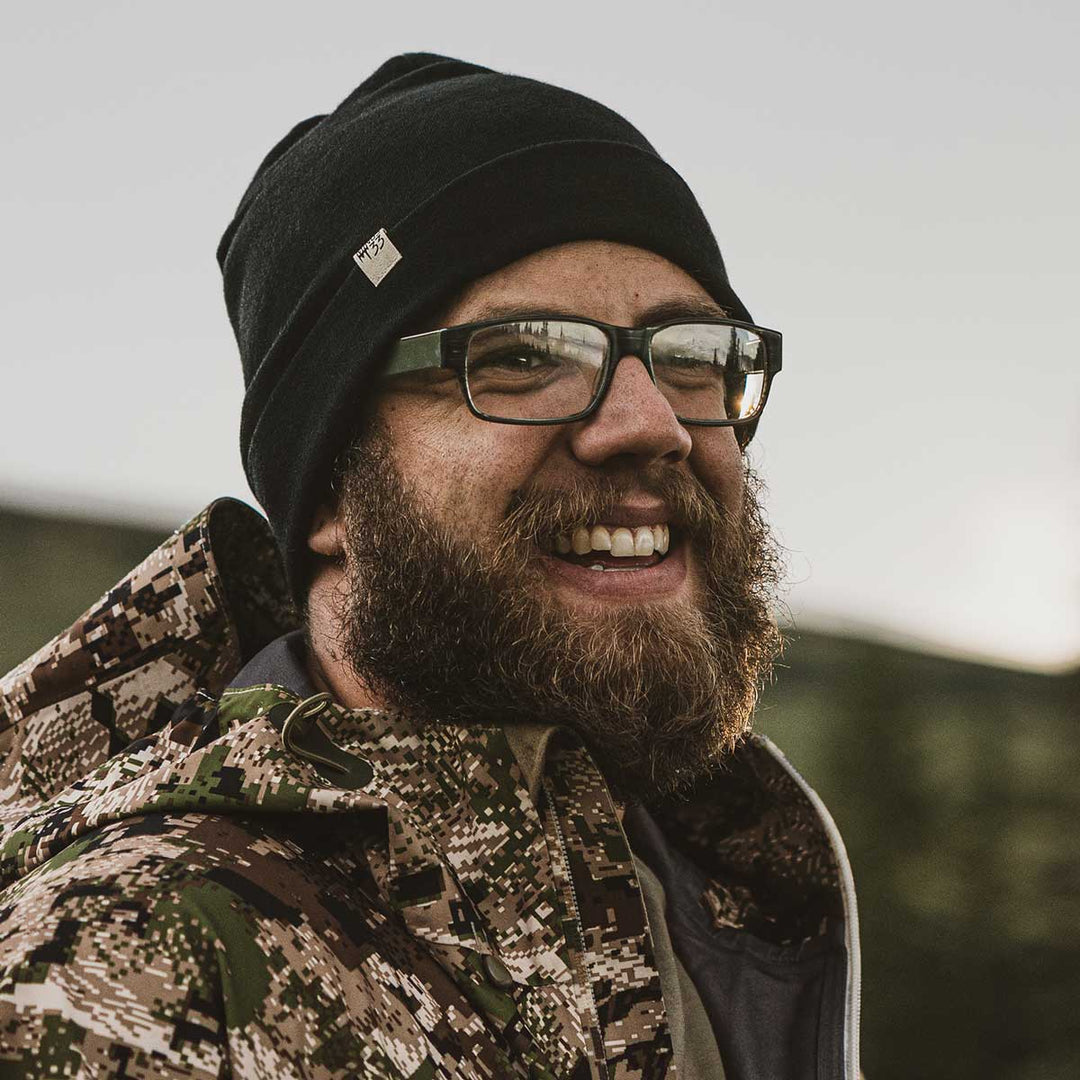 A man models the lightweight, double-layered, hundred percent, super soft merino wool beanie perfect for fall, winter, and spring. This hat is perfect for a hike up the mountain or a walk around the block!
#color_black
