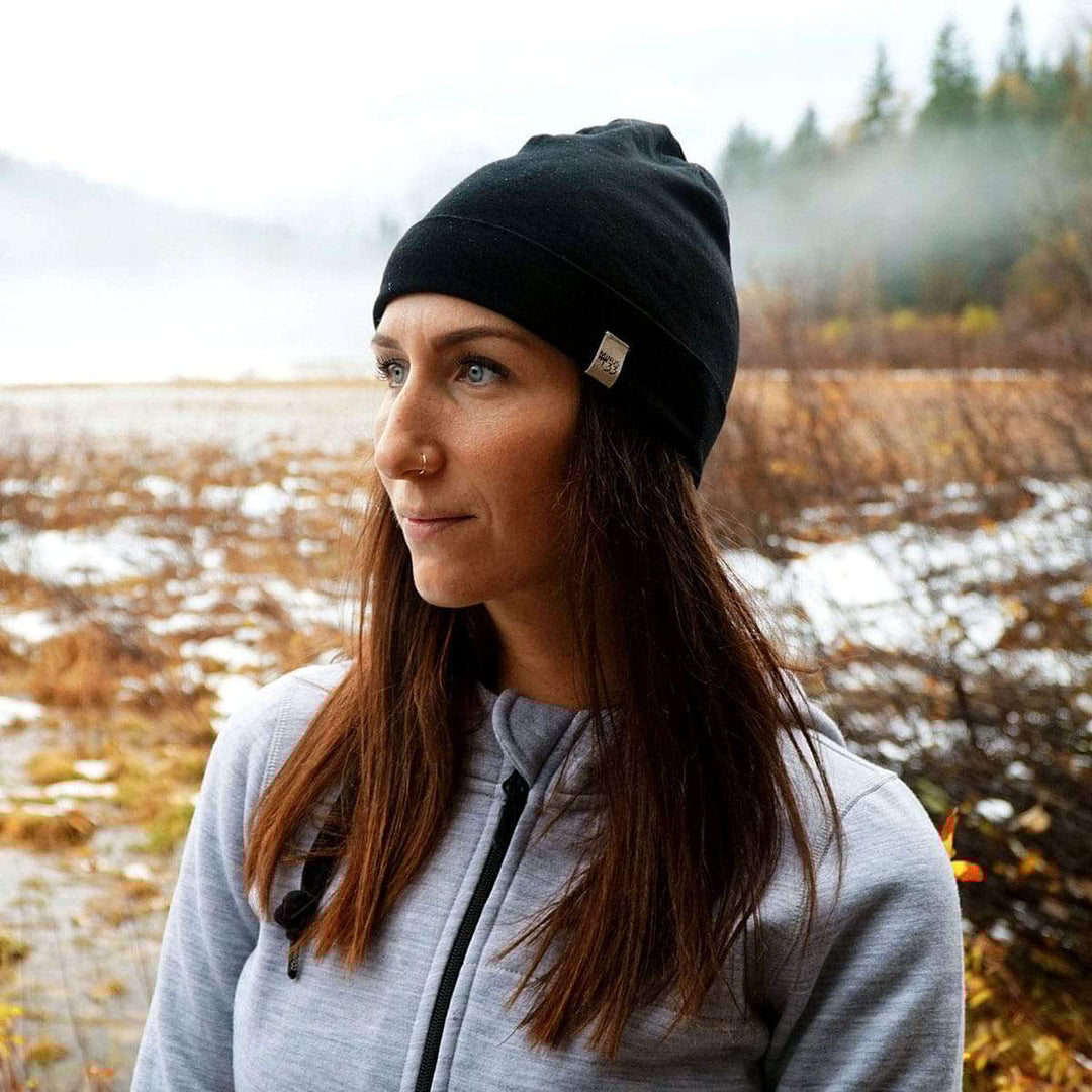 A woman models the lightweight, double-layered, hundred percent, super soft merino wool beanie perfect for fall, winter, and spring. This hat is perfect for a hike up the mountain or a walk around the block!
#color_black