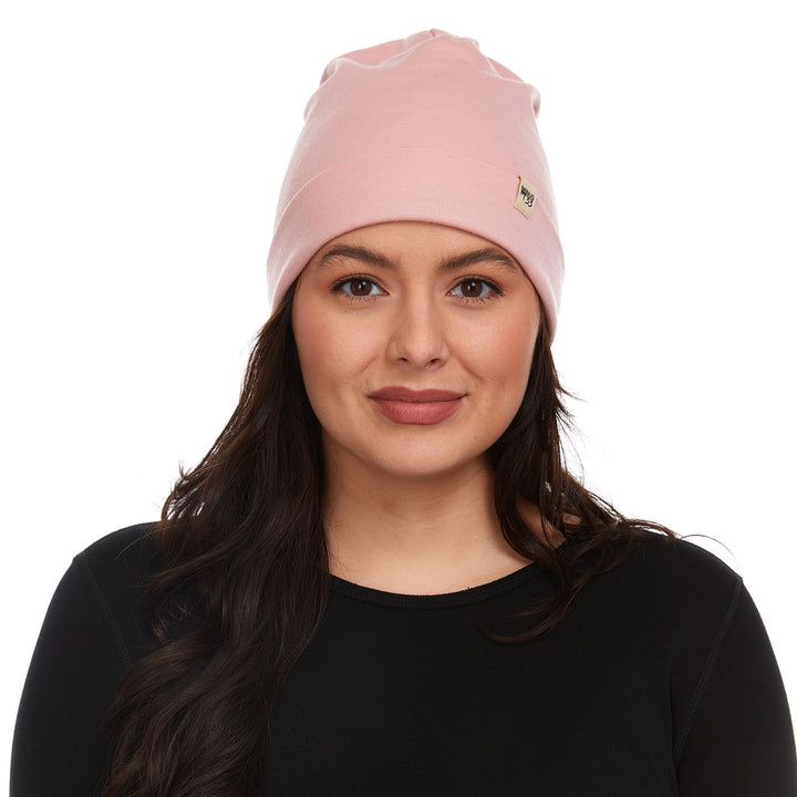 A woman models a lightweight, double-layered, hundred percent, super soft merino wool beanie perfect for fall, winter, and spring. This hat is perfect for a hike up the mountain or a walk around the block!
#color_blush-pink
