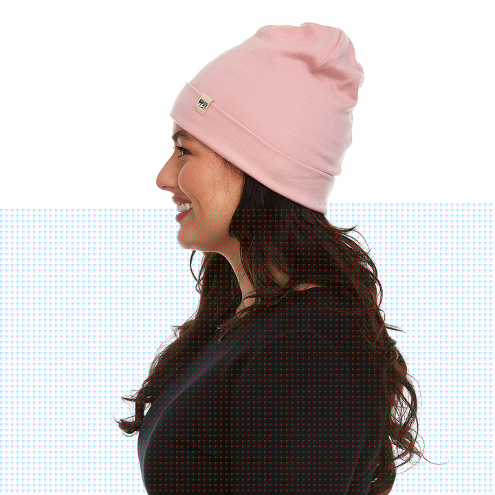 A woman models a lightweight, double-layered, hundred percent, super soft merino wool beanie perfect for fall, winter, and spring. This hat is perfect for a hike up the mountain or a walk around the block!
#color_blush-pink