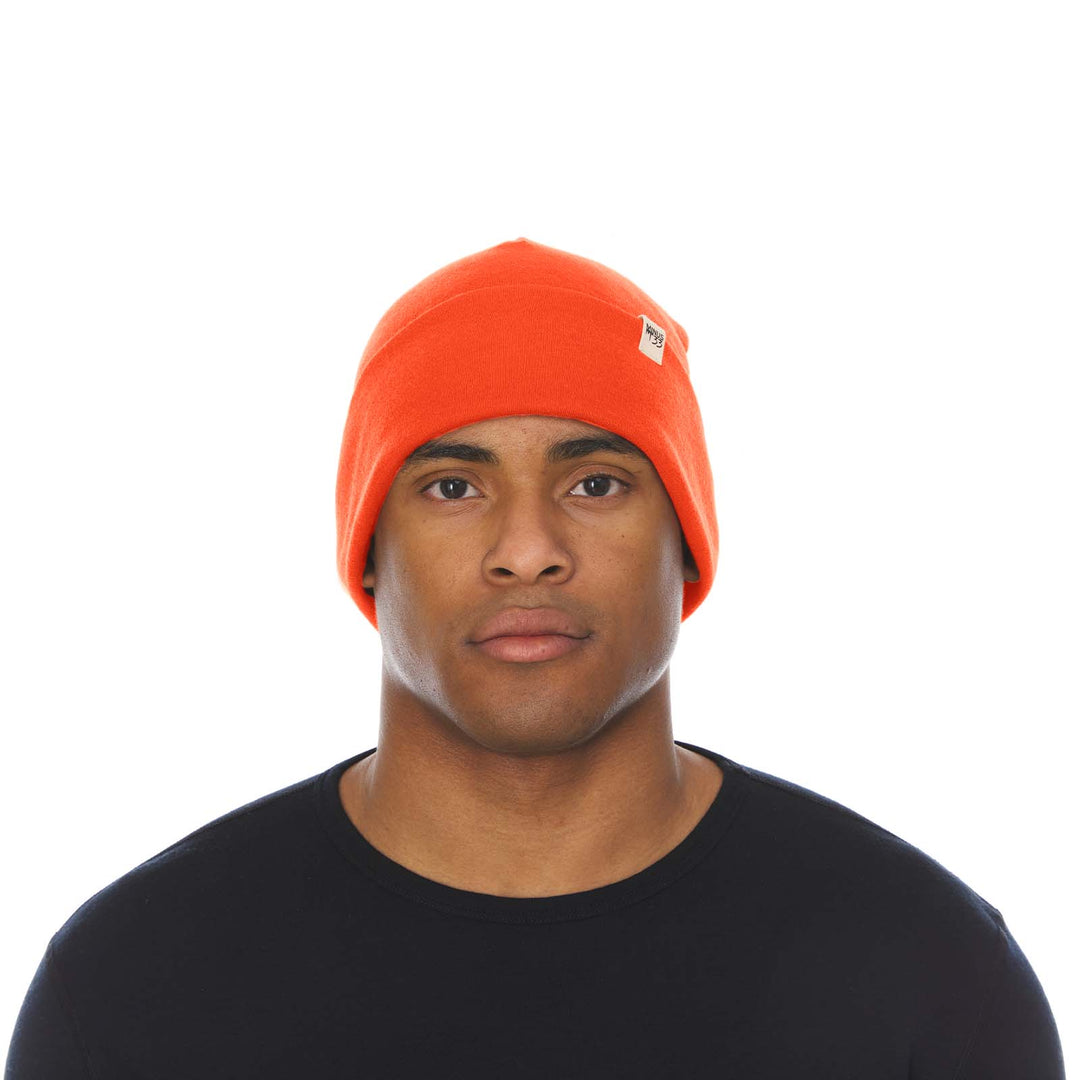 A man models the lightweight, double-layered, hundred percent, super soft merino wool beanie perfect for fall, winter, and spring. This hat is perfect for a hike up the mountain or a walk around the block!
#color_blaze-orange