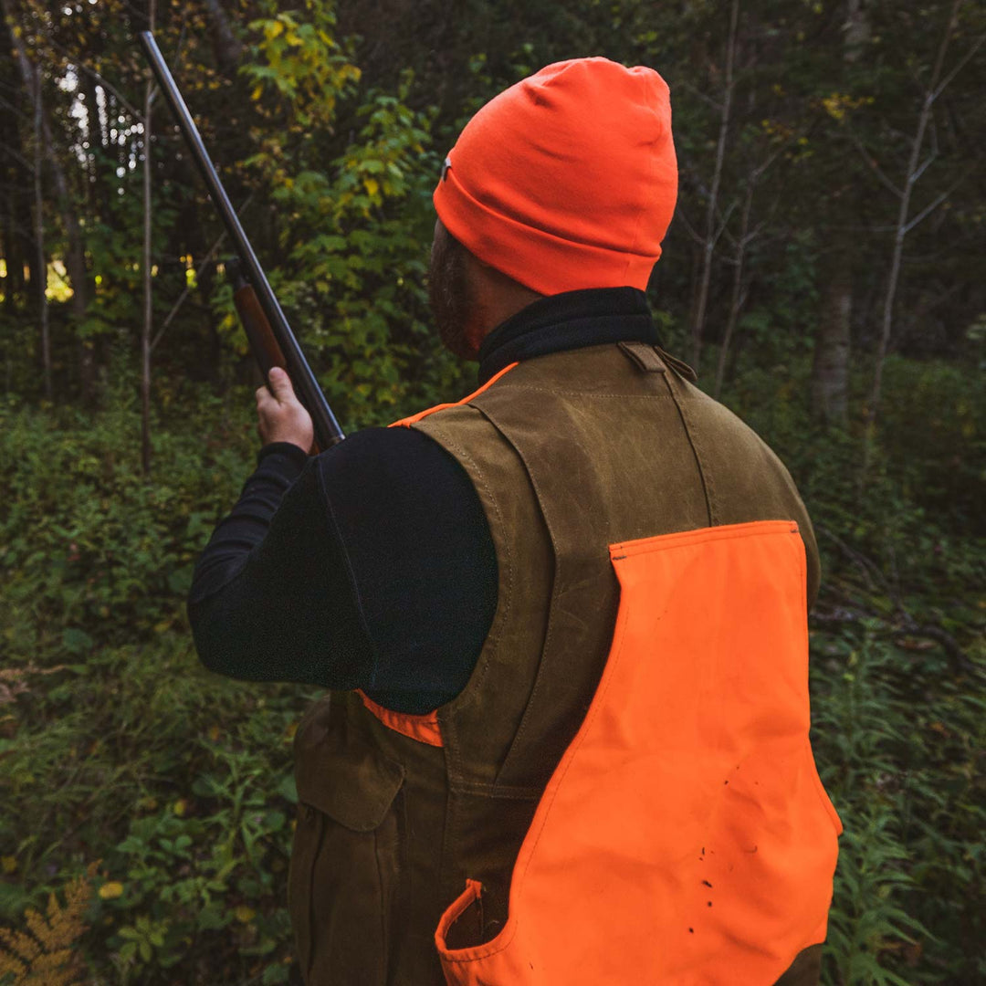 A hunter models the lightweight, double-layered, hundred percent, super soft merino wool beanie perfect for fall, winter, and spring. This hat is perfect for a hike up the mountain or a walk around the block!
#color_blaze-orange