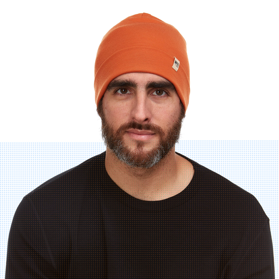 A man models the lightweight, double-layered, hundred percent, super soft merino wool beanie perfect for fall, winter, and spring. This hat is perfect for a hike up the mountain or a walk around the block!
#color_burnt-orange