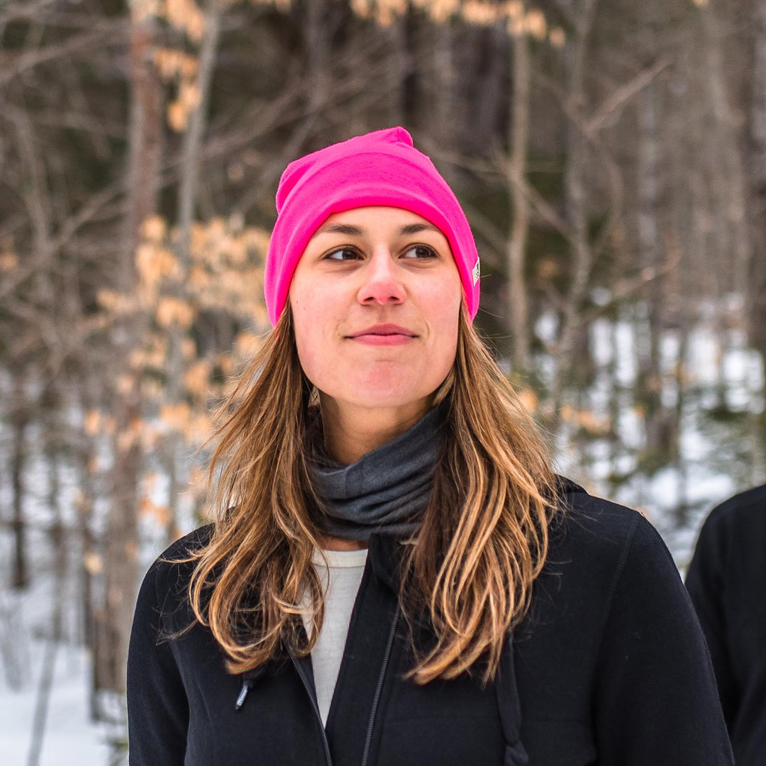 A woman on a snowy trail wears a lightweight, double-layered, hundred percent, super soft merino wool beanie perfect for fall, winter, and spring. This hat is perfect for a hike up the mountain or a walk around the block!
#color_blaze-pink