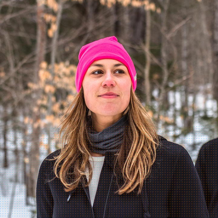 A woman on a snowy trail wears a lightweight, double-layered, hundred percent, super soft merino wool beanie perfect for fall, winter, and spring. This hat is perfect for a hike up the mountain or a walk around the block!
#color_blaze-pink