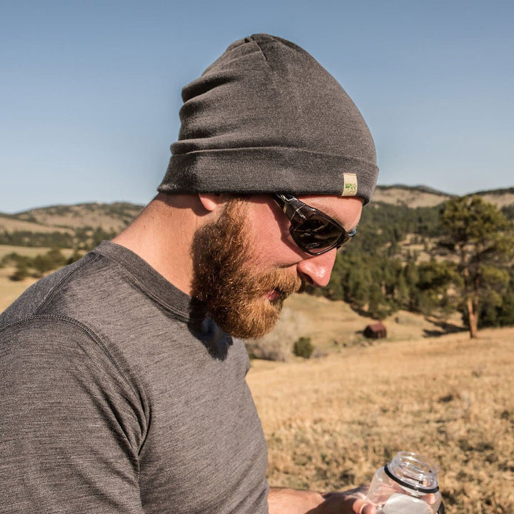 A man models the lightweight, double-layered, hundred percent, super soft merino wool beanie perfect for fall, winter, and spring. This hat is perfect for a hike up the mountain or a walk around the block!
#color_charcoal-gray