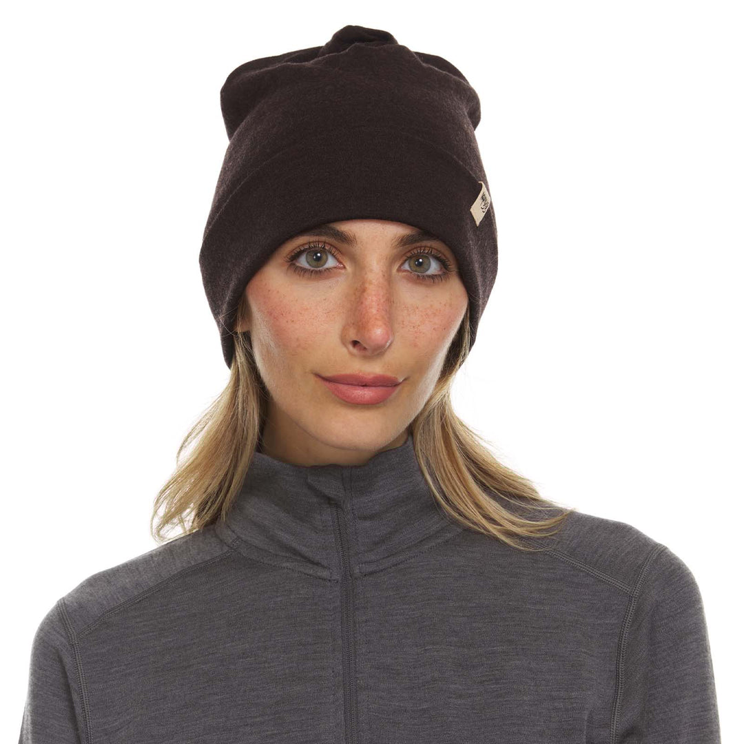 A woman models the lightweight, double-layered, hundred percent, super soft merino wool beanie perfect for fall, winter, and spring. This hat is perfect for a hike up the mountain or a walk around the block!
#color_dark-brown