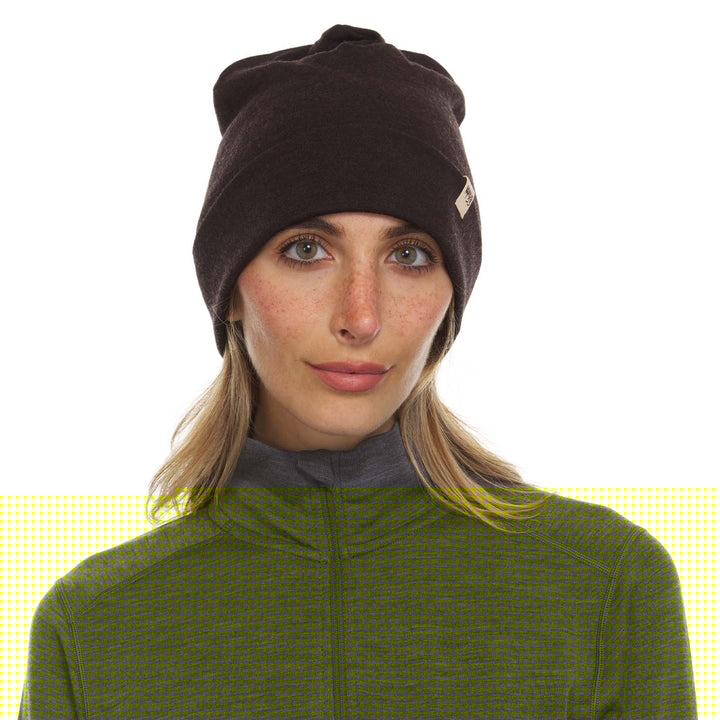 A woman models the lightweight, double-layered, hundred percent, super soft merino wool beanie perfect for fall, winter, and spring. This hat is perfect for a hike up the mountain or a walk around the block!
#color_dark-brown