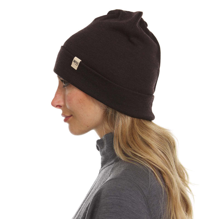 A woman models the lightweight, double-layered, hundred percent, super soft merino wool beanie perfect for fall, winter, and spring. This hat is perfect for a hike up the mountain or a walk around the block!
#color_dark-brown