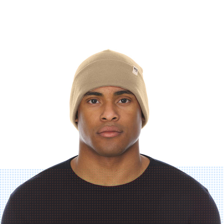 A man models the lightweight, double-layered, hundred percent, super soft merino wool beanie perfect for fall, winter, and spring. This hat is perfect for a hike up the mountain or a walk around the block!
#color_desert-sand