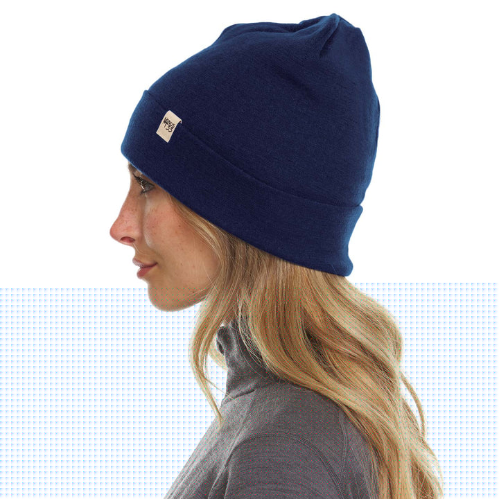A woman models the lightweight, double-layered, hundred percent, super soft merino wool beanie perfect for fall, winter, and spring. This hat is perfect for a hike up the mountain or a walk around the block!
#color_navy