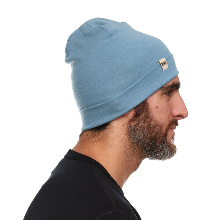 A man models the lightweight, double-layered, hundred percent, super soft merino wool beanie perfect for fall, winter, and spring. This hat is perfect for a hike up the mountain or a walk around the block!
#color_slate-blue