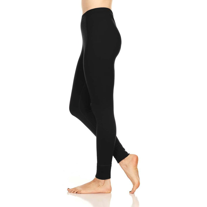 A pair of one hundred percent merino wool lightweight women's base layer bottoms. These bottoms feature a gusset between the legs for improved range of motion, and cuffs around the ankles for comfort and style. #color_black