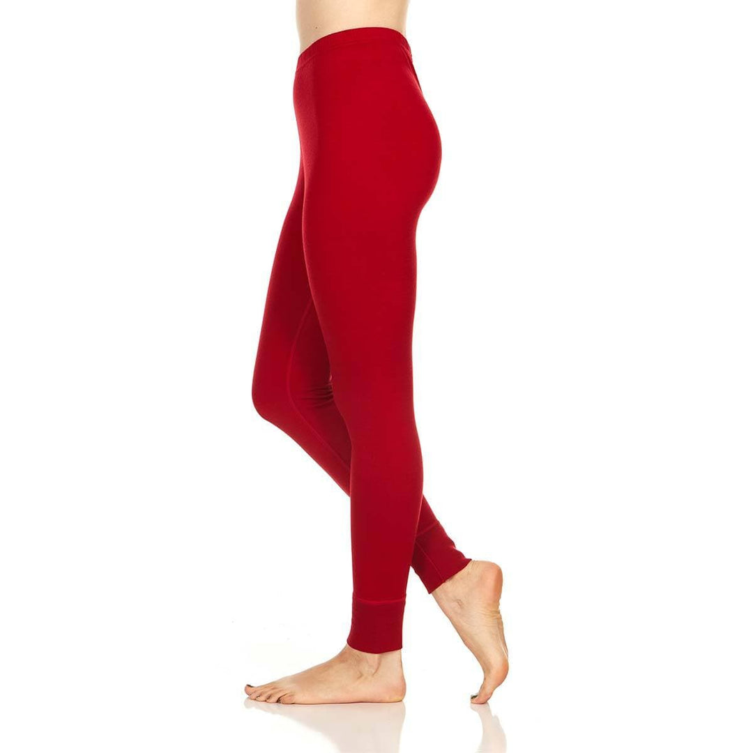 A pair of one hundred percent merino wool lightweight women's base layer bottoms. These bottoms feature a gusset between the legs for improved range of motion, and cuffs around the ankles for comfort and style. #color_true-red