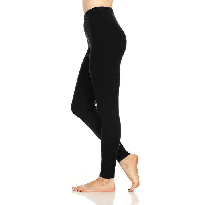 A pair of one hundred percent merino wool midweight women's base layer bottoms. These bottoms feature a gusset between the legs for improved range of motion, and cuffs around the ankles for comfort and style. #color_black