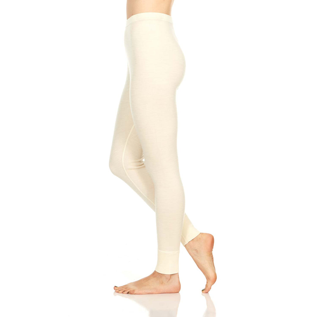 A pair of one hundred percent merino wool midweight women's base layer bottoms. These bottoms feature a gusset between the legs for improved range of motion, and cuffs around the ankles for comfort and style. #color_cream