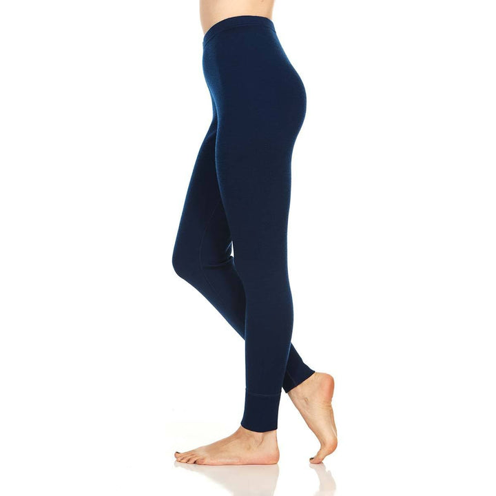 A pair of one hundred percent merino wool midweight women's base layer bottoms. These bottoms feature a gusset between the legs for improved range of motion, and cuffs around the ankles for comfort and style. #color_navy