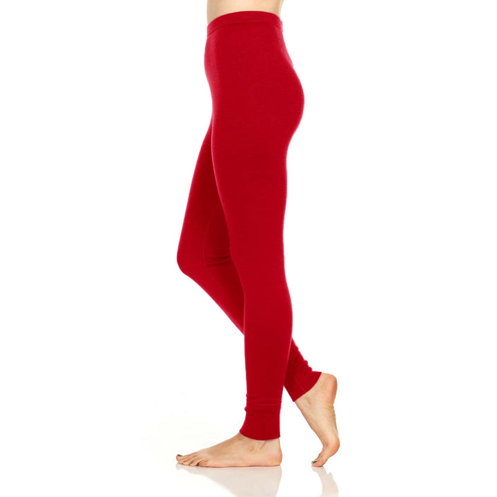 A pair of one hundred percent merino wool midweight women's base layer bottoms. These bottoms feature a gusset between the legs for improved range of motion, and cuffs around the ankles for comfort and style. #color_true-red