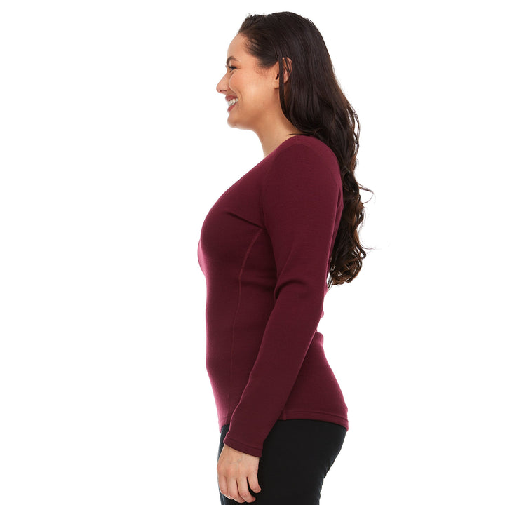 A woman models the one hundred percent merino wool heavyweight women's base layer crew top. This super soft top has a princess cut style for a more flattering fit. #color_burgundy