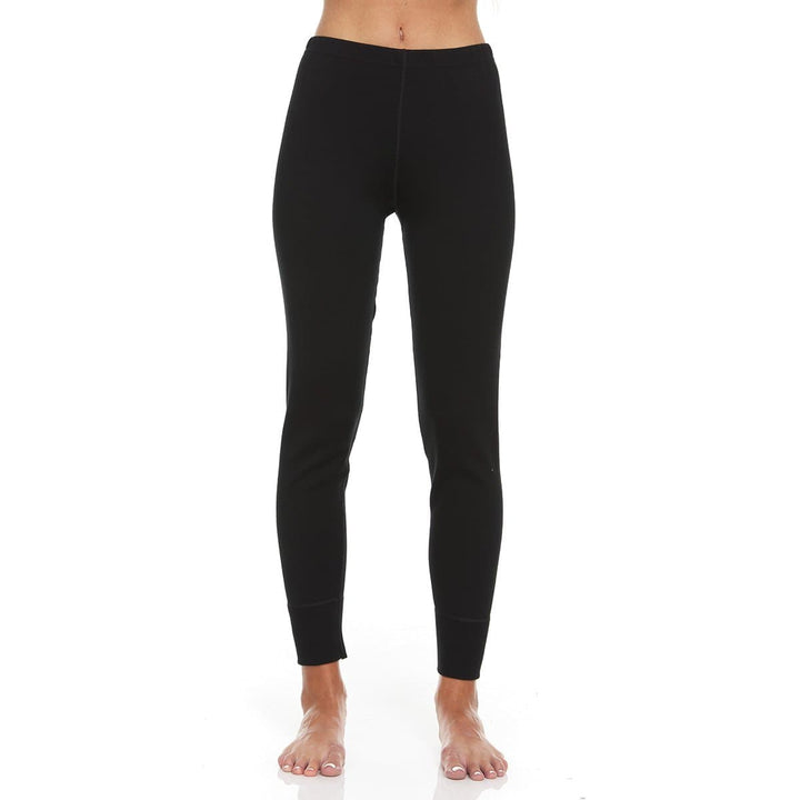 A pair of one hundred percent merino wool heavyweight women's base layer bottoms. These bottoms feature a gusset between the legs for improved range of motion, and cuffs around the ankles for comfort and style. #color_black