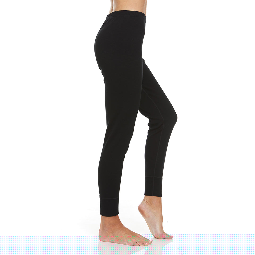 A pair of one hundred percent merino wool heavyweight women's base layer bottoms. These bottoms feature a gusset between the legs for improved range of motion, and cuffs around the ankles for comfort and style. #color_black