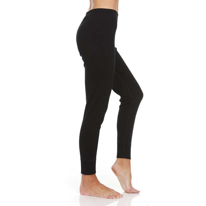 A pair of one hundred percent merino wool heavyweight women's base layer bottoms. These bottoms feature a gusset between the legs for improved range of motion, and cuffs around the ankles for comfort and style. #color_black