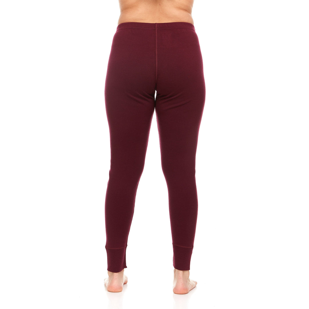 A pair of one hundred percent merino wool heavyweight women's base layer bottoms. These bottoms feature a gusset between the legs for improved range of motion, and cuffs around the ankles for comfort and style. #color_burgundy