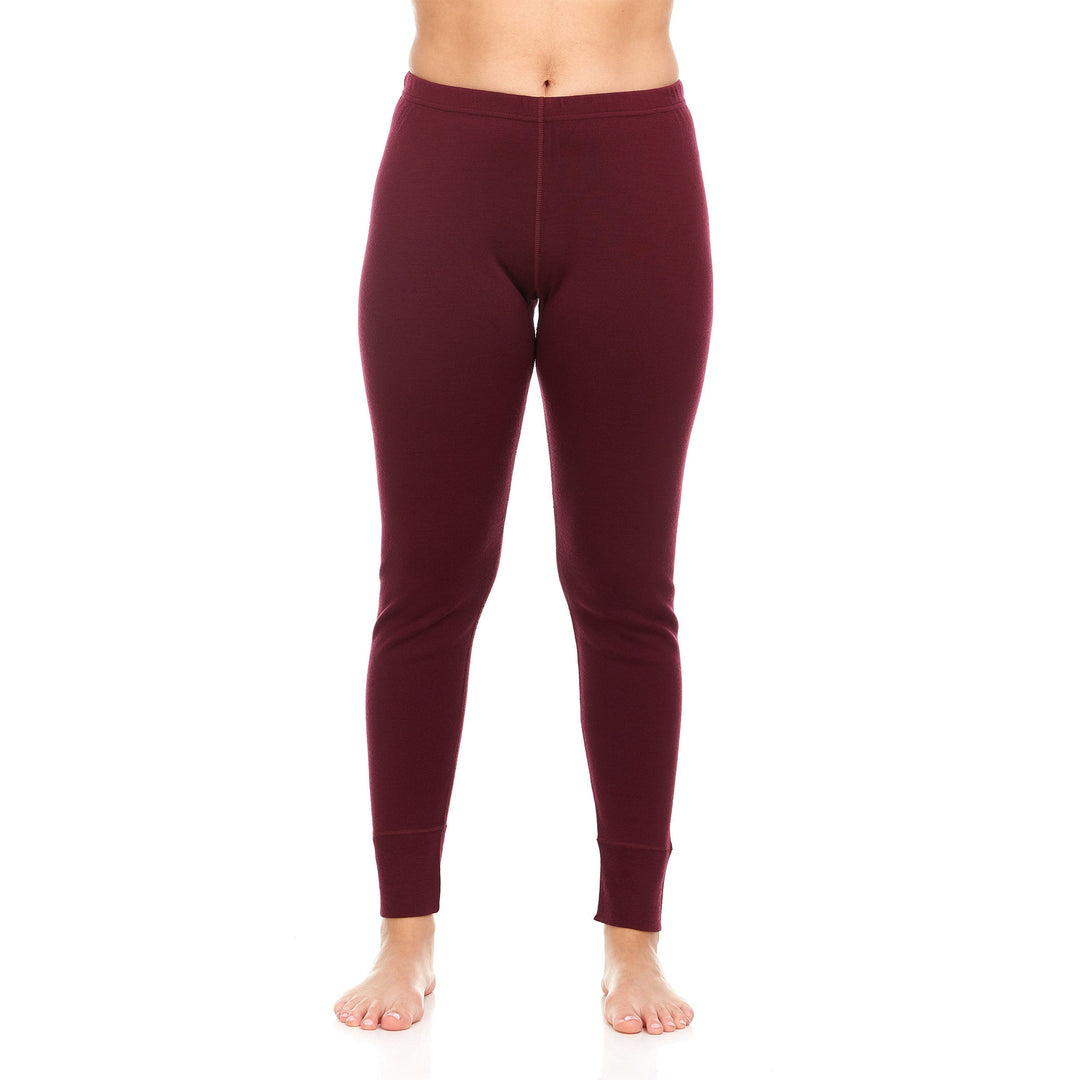 A pair of one hundred percent merino wool heavyweight women's base layer bottoms. These bottoms feature a gusset between the legs for improved range of motion, and cuffs around the ankles for comfort and style. #color_burgundy
