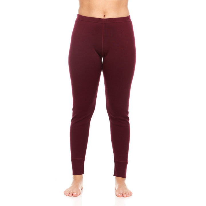 A pair of one hundred percent merino wool heavyweight women's base layer bottoms. These bottoms feature a gusset between the legs for improved range of motion, and cuffs around the ankles for comfort and style. #color_burgundy